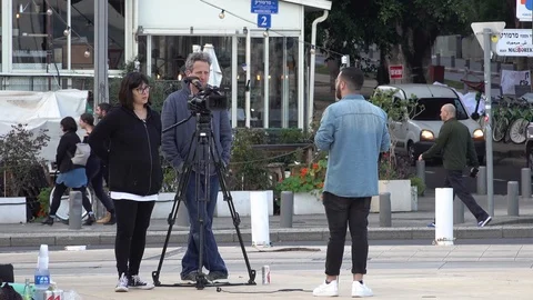 A man is talking in front of a camera in the city Stock Footage 108677178