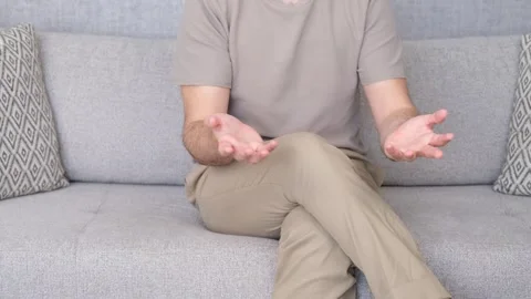 Man talking hand on sofa Stock Footage 265805692