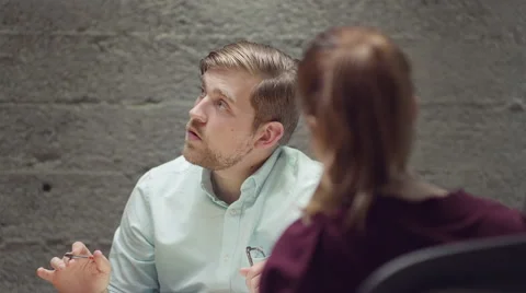 Man talking with his colleagues in a small business meeting Stockbeeldmateriaal 55338171
