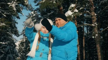 Man talking with his girlfriend in the winter forest . Stock Footage 85516993