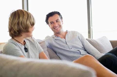 Man talking to his son and smiling Stock Photos