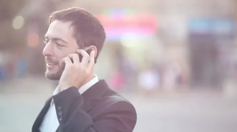 Man talking on Iphone [lens flare] Stock Footage 42254385