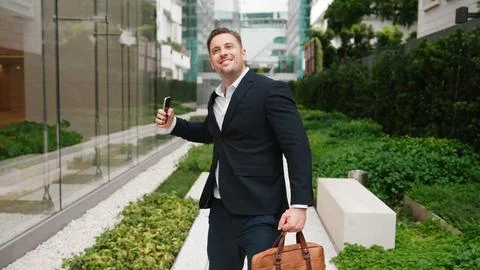 Man talking to manager by using phone and celebrate increasing sales. Urbane. Stock Photos