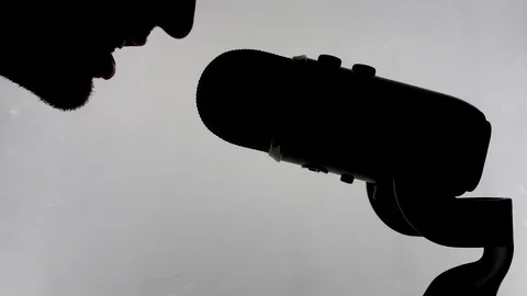 Man talking into microphone isolated Stock Footage 101354409