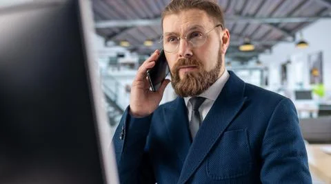Man talking on mobile at office Stock Photos