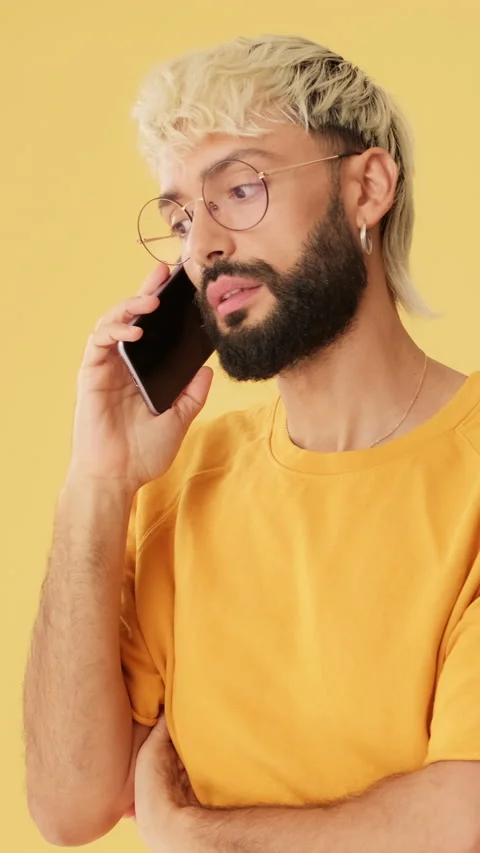 Man talking on mobile phone, isolated on yellow background in studio Stock Footage 254914536