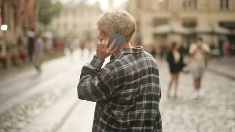 Man talking on mobile phone outdoor. Guy using smart phone on the corner of road Stock Footage 159655876