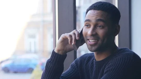 Man talking on mobile phone while sitting in cafe Video stock 72280587