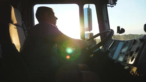 Man talking on mobile phone while driving a truck. Caucasian guy is riding Stock Footage 247892280