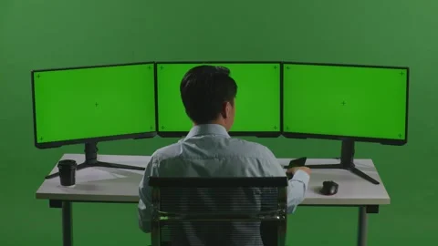 Man Talking On Mobile Phone While Working With Mock Up Multiple Computer Monitor Stock Footage 249625214