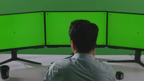 Man Talking On Mobile Phone While Working With Mock Up Multiple Computer Stock Footage 249633859