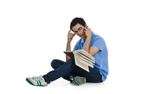 Man talking on a mobile phone while reading a book Fotos Stock