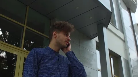Man talking on the phone at the building Stock Footage 68592632