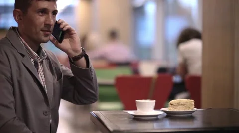 A man is talking on phone in cafe Stock Footage 57850168