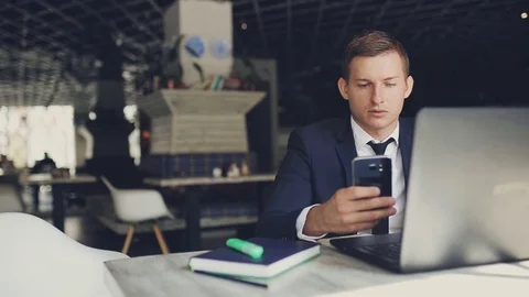 Man talking on the phone in a cafe Stock Footage 83645845