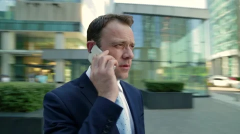 Man talking on the phone. Camera moves around the man, timelapse Stock-Footage 68385260