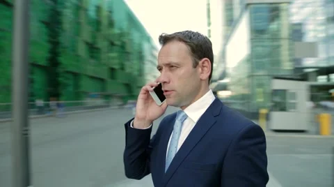 Man talking on the phone. Camera moves around the man Stock Footage 68385309