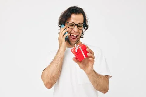 Man talking on the phone gift box isolated background Fotos Stock