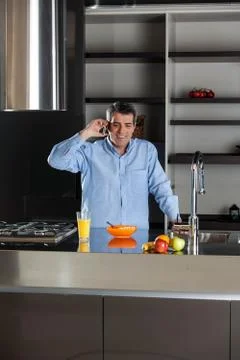 Man talking phone in the kitchen Stock Photos