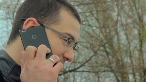 Man talking on the phone in nature Stock Footage 89775338