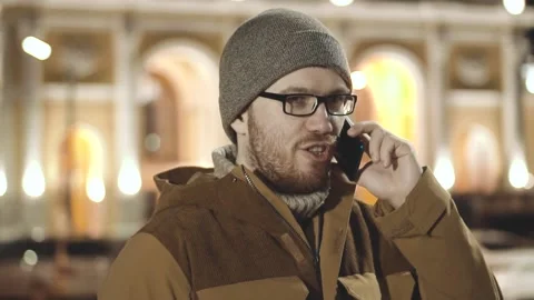 A man is talking on the phone very tensely, figuring out something Stock Footage 201613283