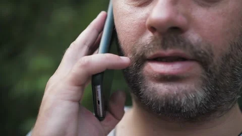 Man talking on the phone for a walk, close up Stock Footage 139760519