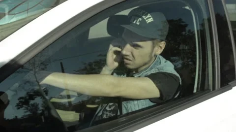 Man talking on the phone while driving a vehicle. Stock Footage 51756854