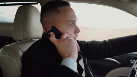 A man talking on the phone while driving. Stock Footage 157583436