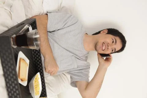 Man talking by phone while having breakfast Stock Photos
