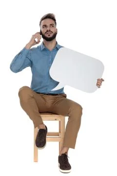 Man talking on the phone while holding blank speak cloud Stock Photos