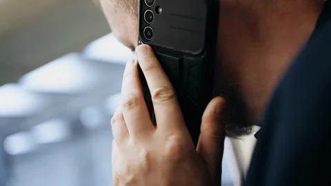A man is talking on the phone while standing in a subway car Stock Footage 335817331