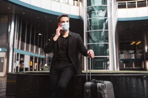 Man talking on phone while waiting for his flight Stock Photos