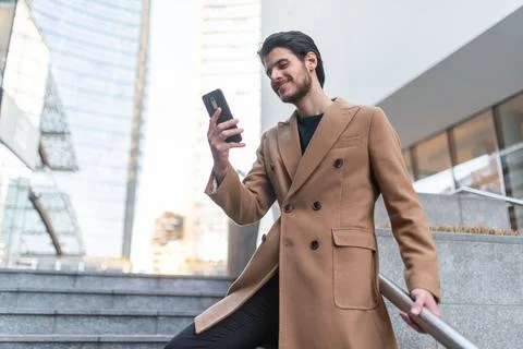 Man talking on the phone while walking down a stair Stock Photos