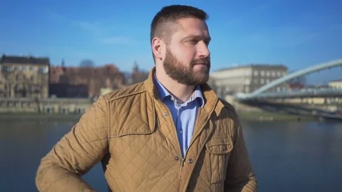 Man talking by smartphone on the background of the river, sunny day Vídeo Stock 72709666