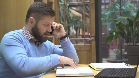 Man talking by smartphone, browsing calendar in pub, cafe, indoor, steadicam 库存影片 73072799