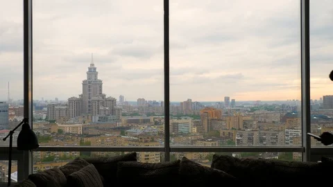 Man talking on the smartphone enters frame and exits near the panoramic window Stock Footage 103200024