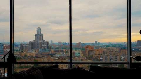 Man talking on the smartphone enters frame and exits near the panoramic window Stock Footage 103200053