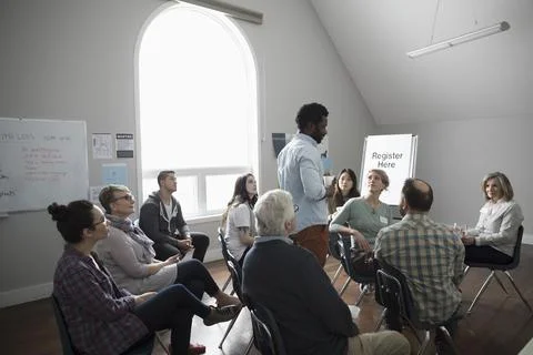 Man talking at support group in community center Stock Photos