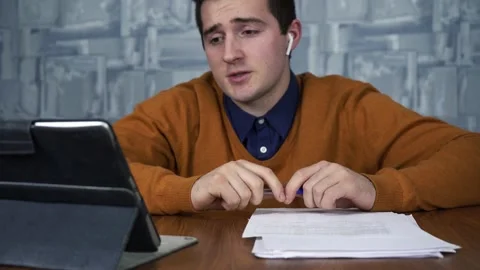 Man talking on a tablet with clients from the office. video communications Stock Footage 157710883