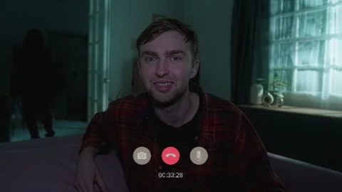 Man Talking on Video Call Unaware of Criminal in House Stock Footage 311566985