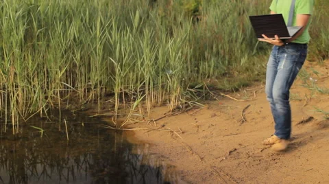 A man talking on a video on a laptop computer at the coast Video stock 64659938