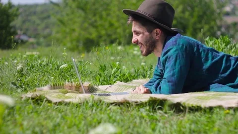 A man is talking on video in a nature Stock Footage 76488320