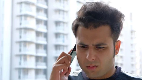 Man talks animately on his smart hone mobile Stock Footage 100618083