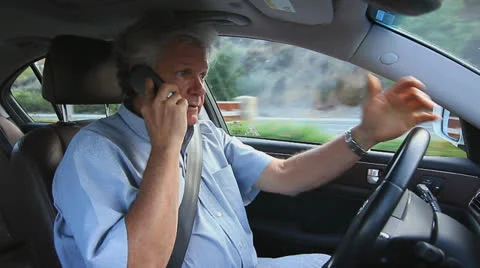 MAN TALKS ON CELL PHONE WHILE DRIVING Stock Footage 23377457