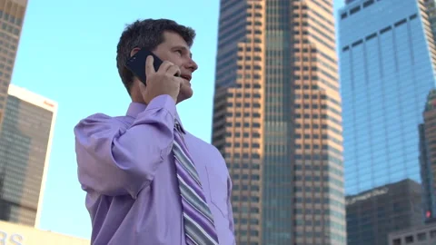 Man talks on cellphone in downtown 2 Stock Footage 201502378