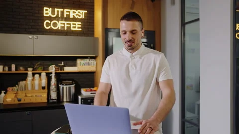 A man talks to his team on a video call from a laptop in the office Stock Footage 201921671