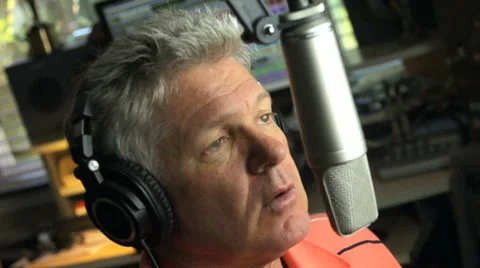 MAN TALKS INTO MICROPHONE Stock Footage 7834877