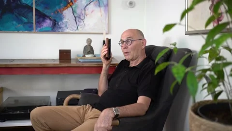 Man talks on phone speaker Stock Footage 147030010