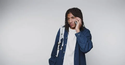 Man talks on the phone while standing in a studio showing different express.. 스톡 동영상 328248605