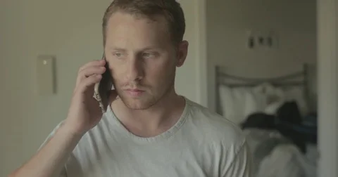 Man talks on smartphone at home Stock Footage 78038098